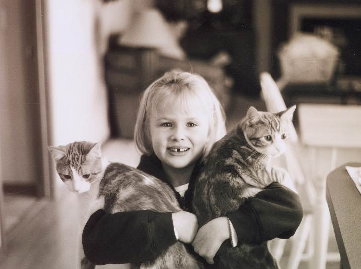 girl hugging animals